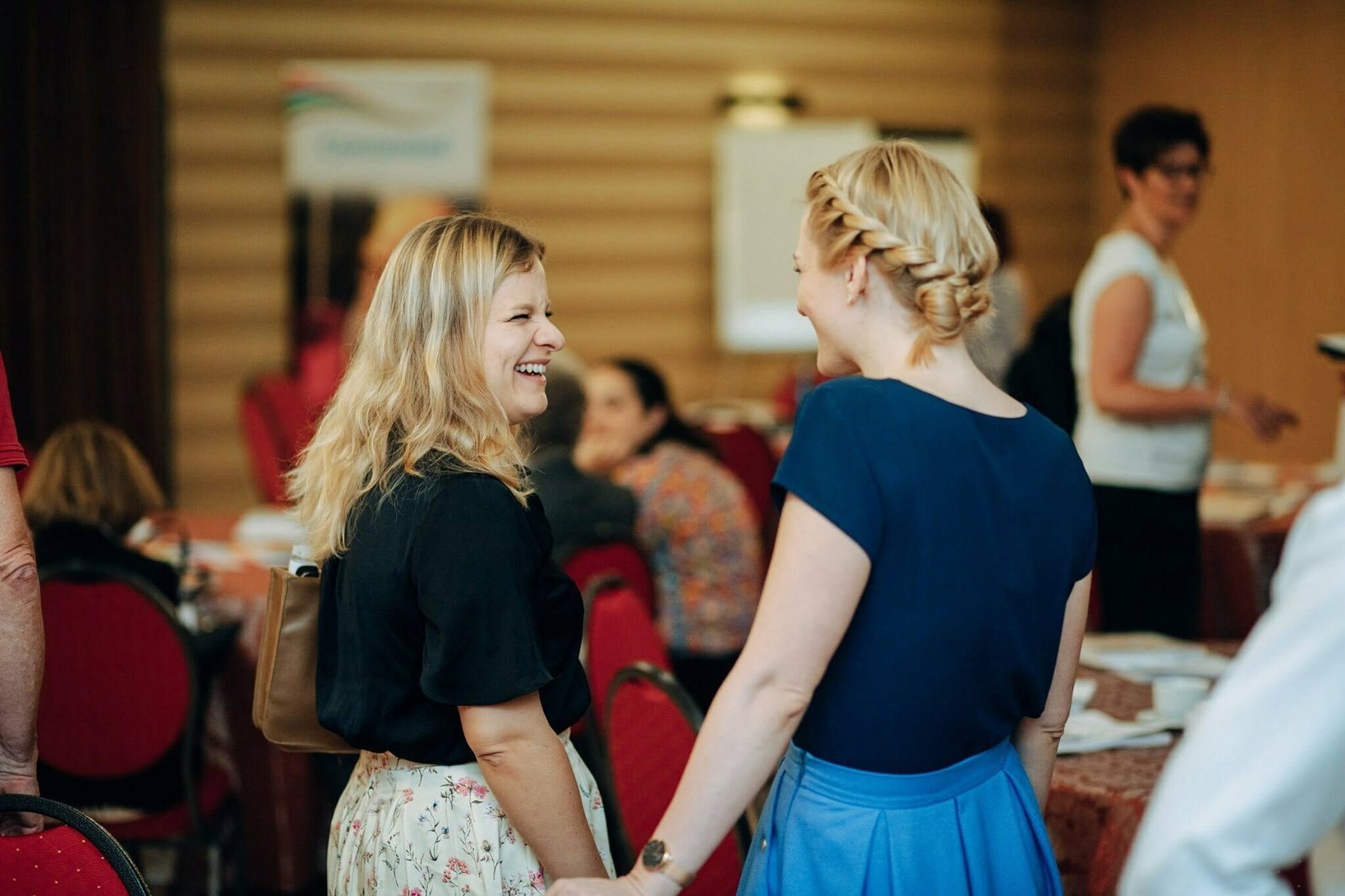 two women talking at conference